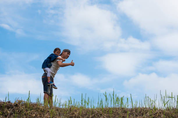 Father and daughter playing in the meadow