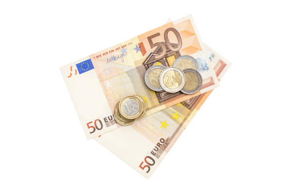 istock Euro coins with two 50 euro bills on white background. Top view. 943968314