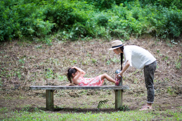 istock Mother and daughter playing in the park 943968316