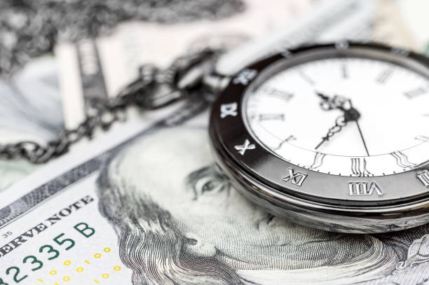 istock Pocket watch on dollar bills. Close up. 943968434