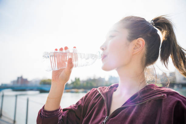 istock Young woman drinking water 943970668