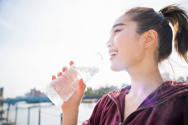 istock Young woman drinking water 943970690