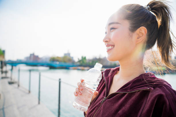 istock Young woman drinking water 943970734