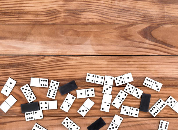 istock Dominoes on wooden background. Top view. Frame. Copy space for text. 943971330