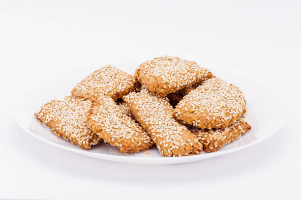 istock On a white plate, on a white background fresh biscuits to sesame. 943978442