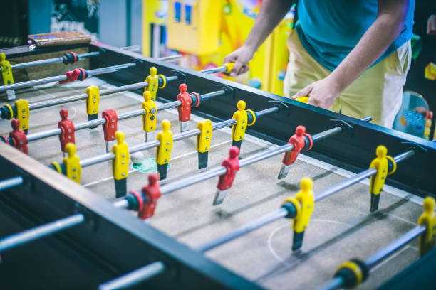 istock Friends having fun together playing table football. 943978610