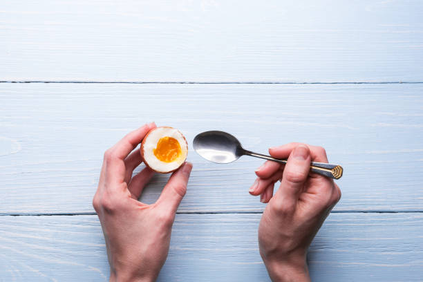 boiled eggs in hands on a wooden background