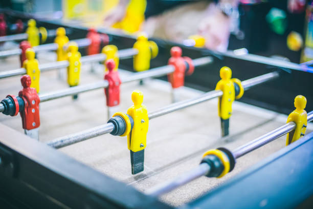 istock Friends having fun together playing table football. 943982266