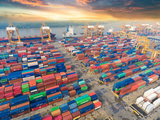 istock Logistics and transportation of Container Cargo ship and Cargo working crane bridge in shipyard 943988210