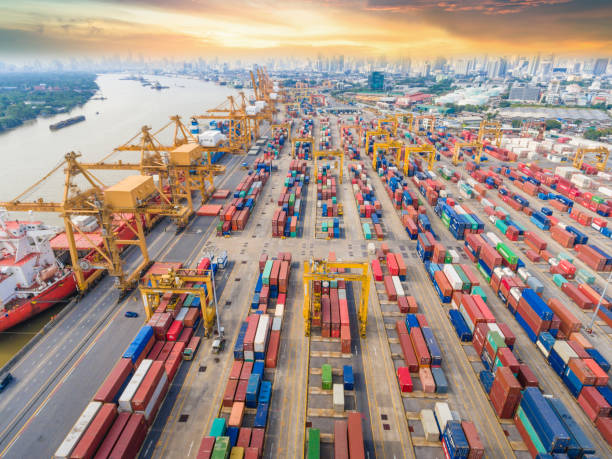 istock Logistics and transportation of Container Cargo ship and Cargo working crane bridge in shipyard 943988484