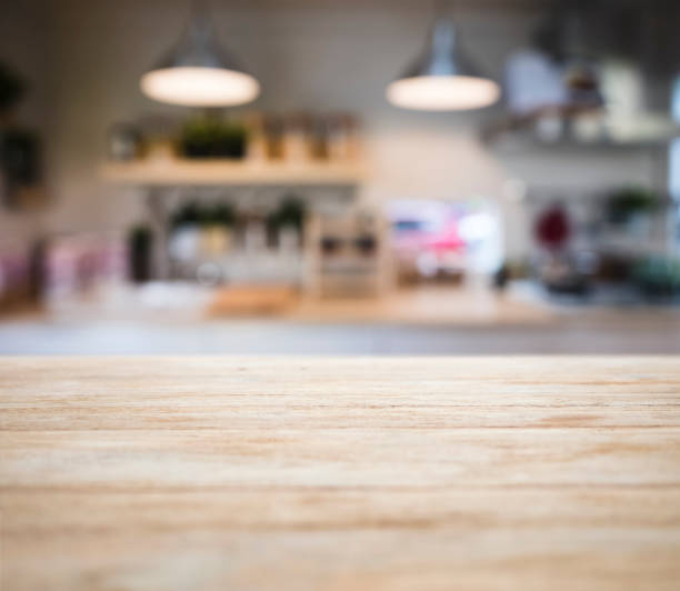 istock Table top wooden counter Blur Kitchen Shelf and lighting background 943993230