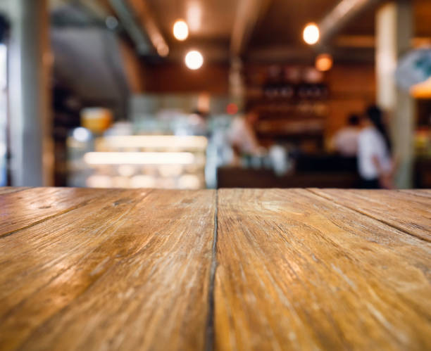 istock Table top counter Blur bar restaurant cafe with people background 943993236