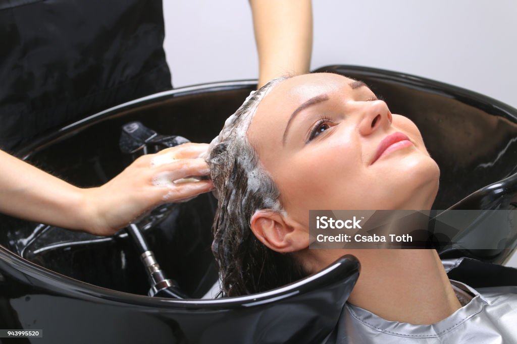 Hairdresser washing woman's hair in hairdresser salon 20-24 Years Stock Photo