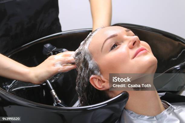 Hairdresser Washing Womans Hair In Hairdresser Salon Stock Photo - Download Image Now