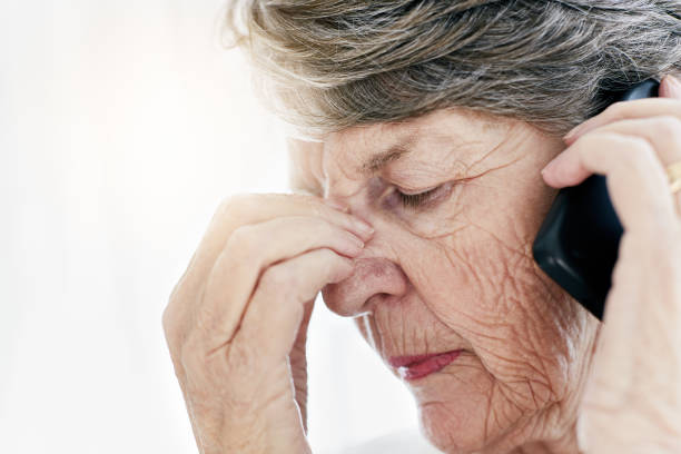 istock Frowning old woman with mobile phone gets bad news 943996370