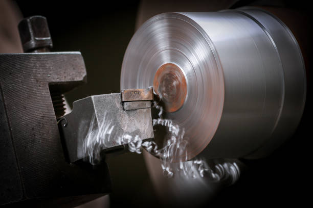 istock Metal worker shaping metal on lathe 943998154