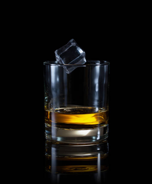 istock Glass of whiskey with flying ice cube 943999240