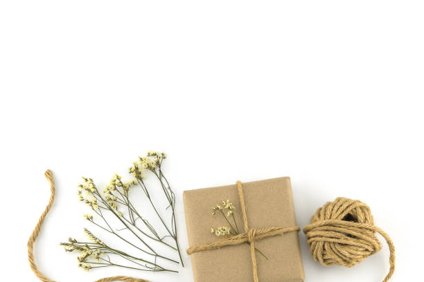istock Brown gift boxes and rope with yellow limonium caspia flowers 944000824