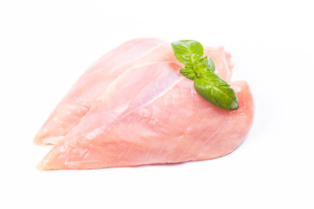 istock Raw chicken fillet with basil isolated on white 944001722
