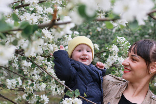 istock girl with daughter in a spring apple garden 944001752