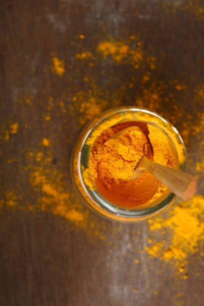 istock Turmeric powder in jar top view, spices 944005186