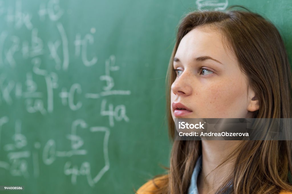 Teenager girl in math class overwhelmed by the math formula. Pressure, Education, Success concept. Anxiety Stock Photo