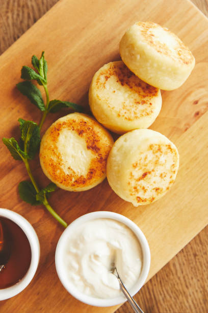 istock Cheese pancakes served with honey and sour cream 944008914