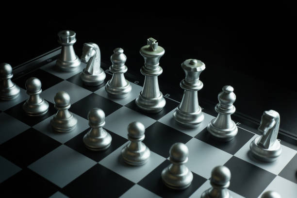 istock gold and silver chess on board close up image abstract Background. 944011648