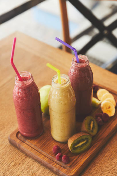 istock Bottles with smoothies from fresh fruits and berries on table 944011920