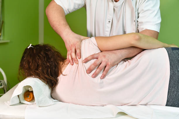 istock physiotherapist massaging woman shoulder 944015232