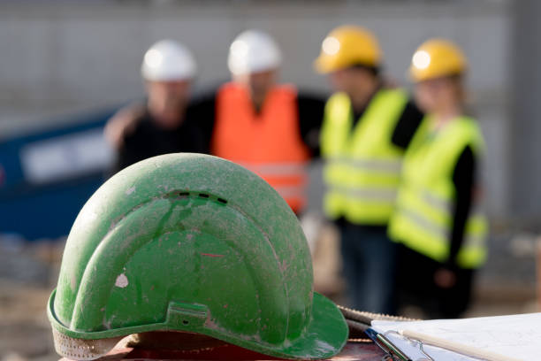 istock Green safety hardhat on out of focused background 944015422