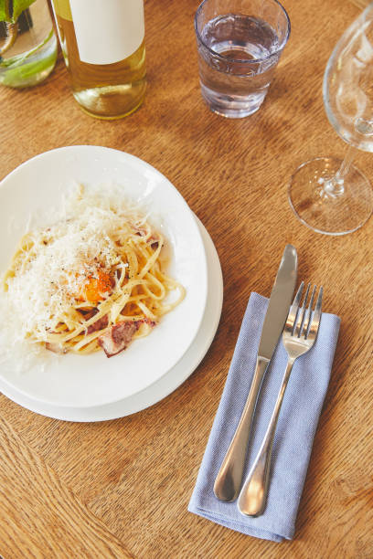 istock Italian carbonara pasta served with wine 944015526