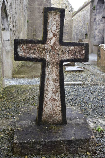 istock Cross tombstone in abbey ruins 944016066