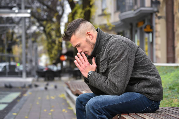 istock young sad man thinking while sitting on a bench in autumn 944016234