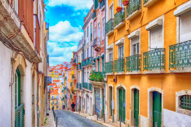 Lisbon, Portugal city street view Lisbon, Portugal street perspective view with colorful traditional houses portugal photos stock pictures, royalty-free photos & images