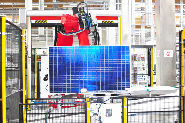 high tech industrie - production of solar cells - working robot in the production line with a finished photovoltaic cell - industrie imagens e fotografias de stock