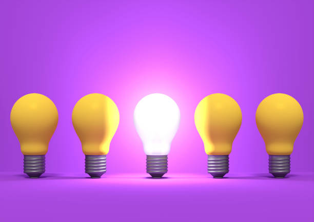 istock Illuminated incandescent light bulb among the group of yellow bulbs 944022438