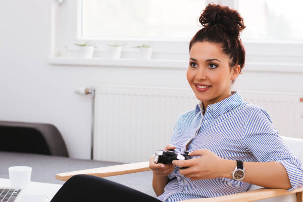 istock Beautiful young girl playing video games 944023056