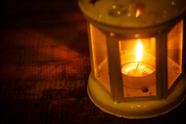 istock Retro style lantern with a candle at night 944025722