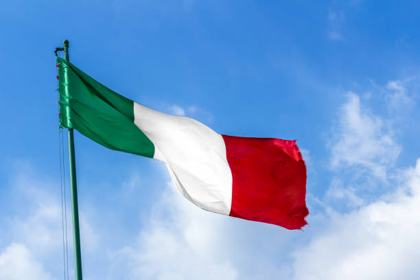 istock Waving Italian flag against blue sky 944025728