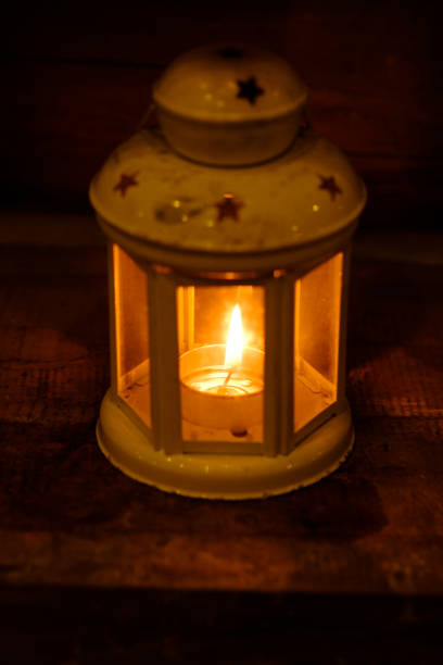 istock Retro style lantern with a candle at night 944025736