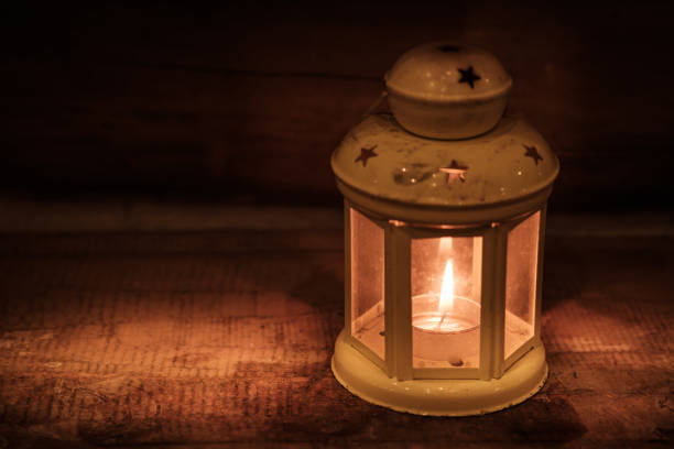 istock Retro style lantern with a candle at night 944025754