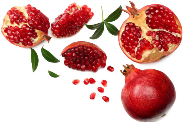 istock pomegranate fruit with green leaves isolated on a white background top view 944028392