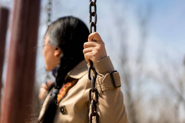 girl playing swing in park
