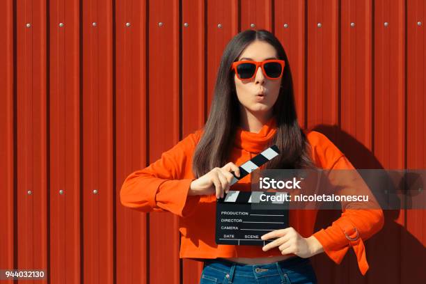 Beautiful Woman With Cinema Clapper On Red Background Stock Photo - Download Image Now