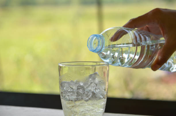 istock Hand on pouring drink water to glass 944034932