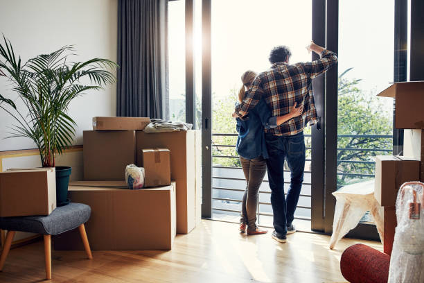 this is our new start - moving house apartment couple box imagens e fotografias de stock