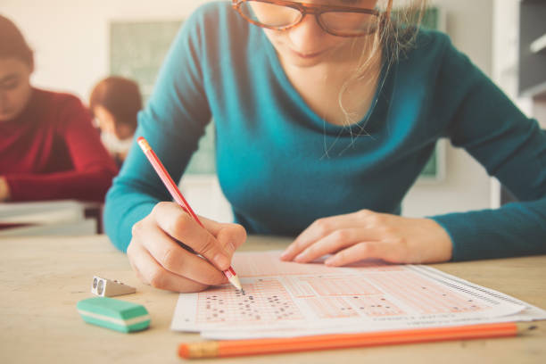 School grade. Red letter A with plus symbol on notebook paper, top view