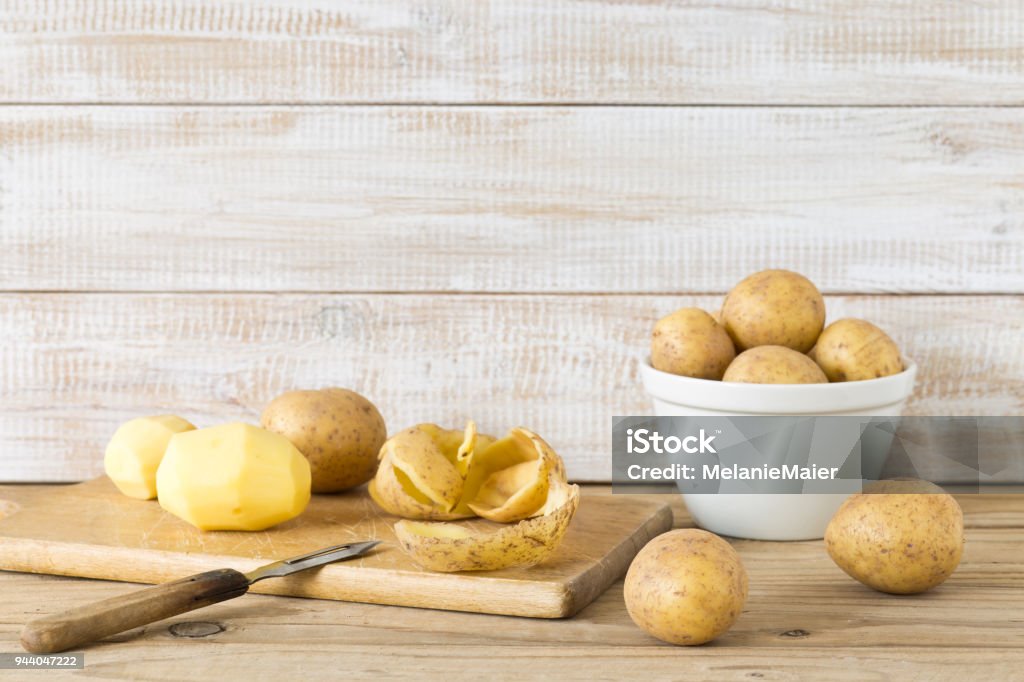 Raw and peeled potatoes Raw Potato Stock Photo