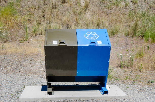 istock Recycling and Garbage Bin with Dry Grass in Background 944051550
